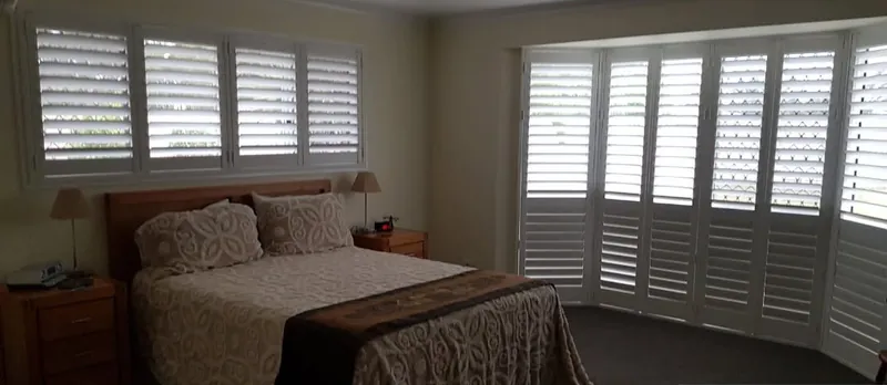A bedroom with plantation shutters fitted by GNB