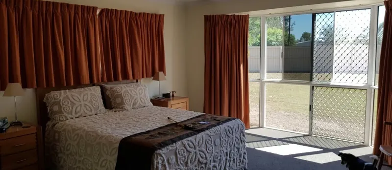 Before: heavy curtains to plantation shutters