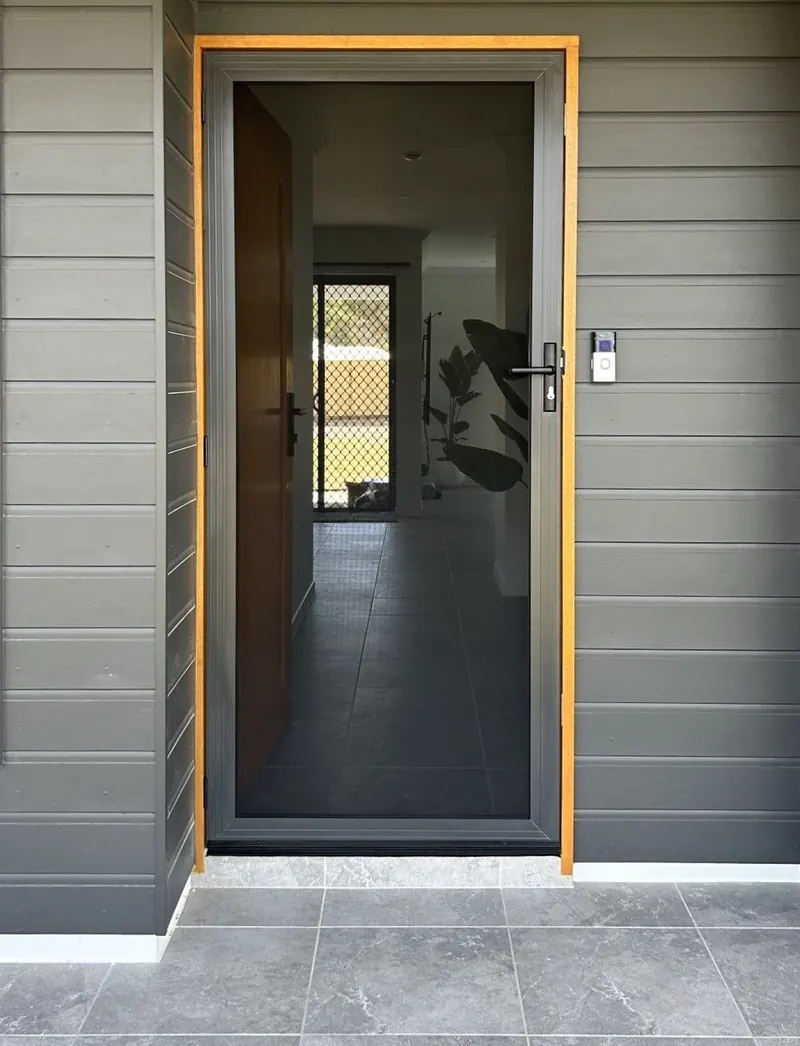 Invisi-Gard hinged security door on a grey clad home