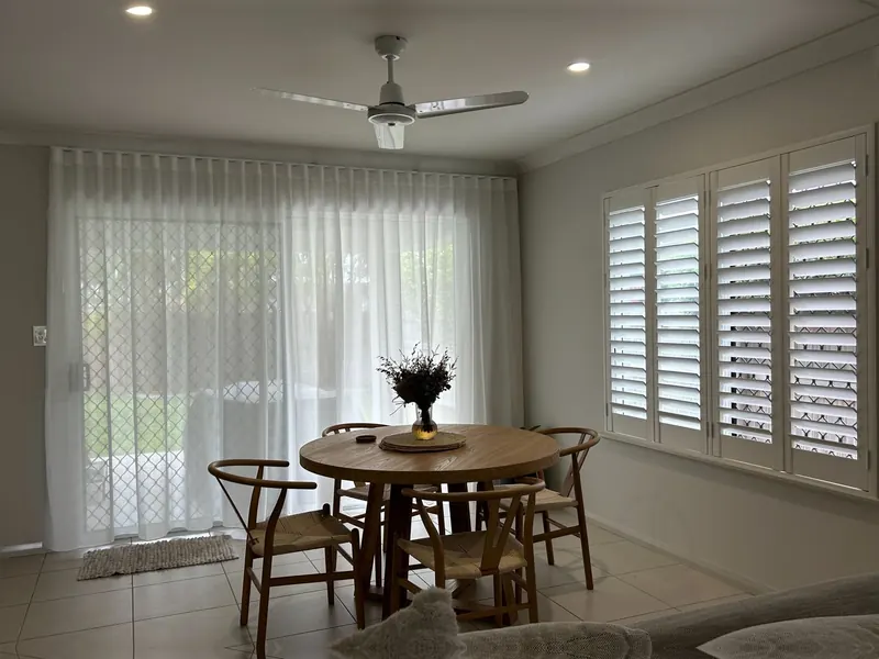 S-Fold curtains and plantation shutters in a dining room
